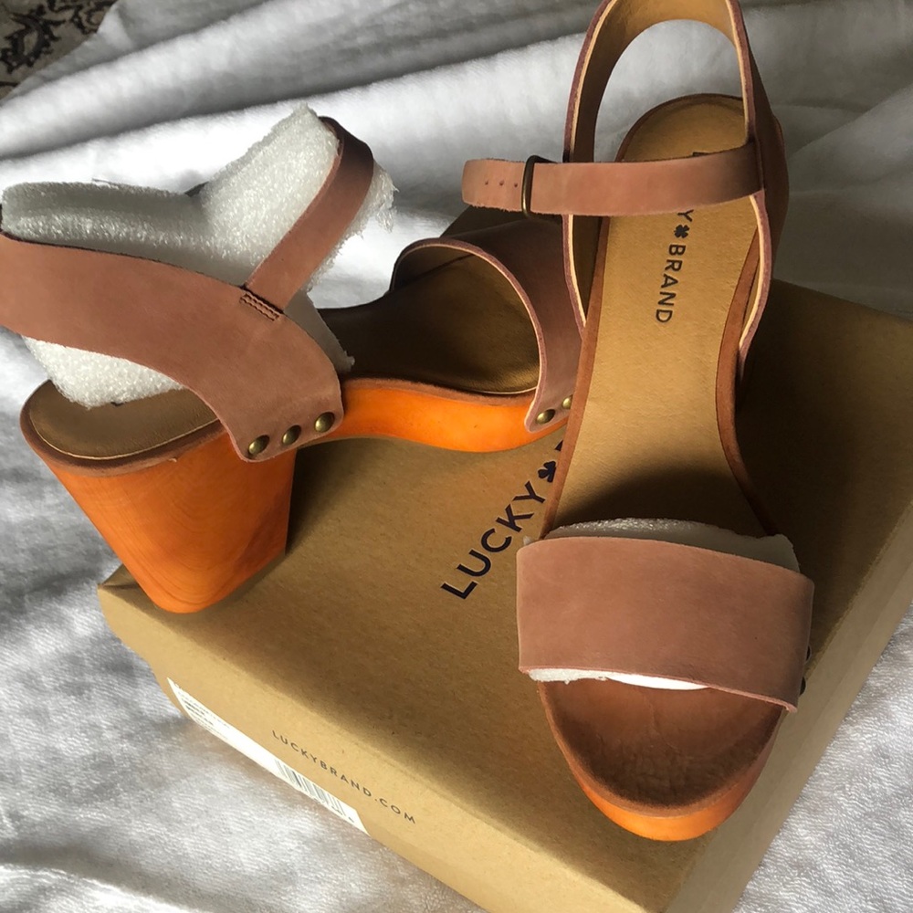 Brown/cocoa color leather saddle. Wooden heel, size 8 1/2 never worn.